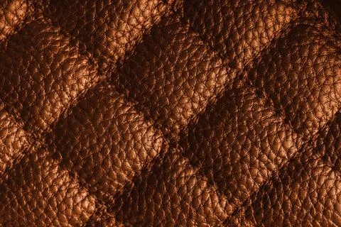 Macro of orange quilted leather texture background with stitched pattern an.. Foto stock