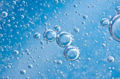 Macro Oxygen bubbles in blue clear water Stock Photos