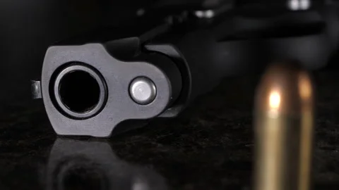 Macro Pan Left with Focus pull, Bullet and Gun Stock Footage 237032728