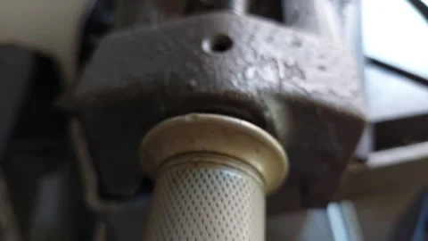 Macro pan shot of a heavy duty metal workshop vise screw thread and handle mecha Stock Footage 336482717