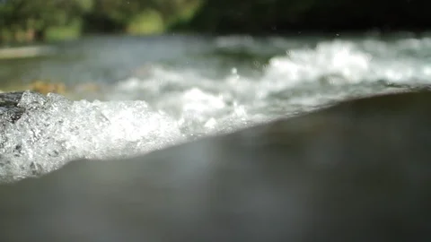 Macro pan shot of the surface of a small creek Stock Footage 86742111
