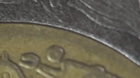 Macro Panning Shot Across Coin Surface Revealing Engraved Details and Texture Stock Footage 338413498
