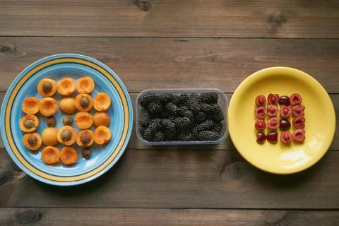 Macro pattern from apricots and cherries on a plates Stock Photos