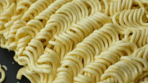 Macro pattern of dry yellow wavy instant noodles Stock Footage 346603783