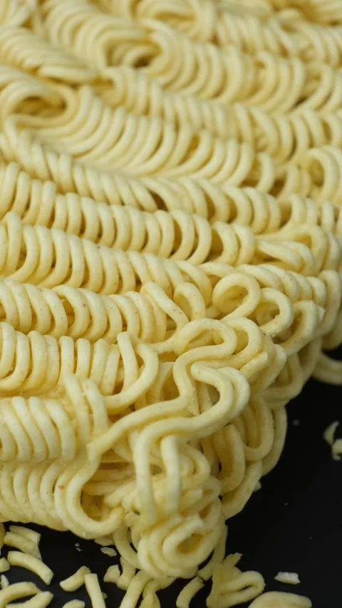 Macro pattern of dry yellow wavy instant noodles Stock Footage 346883724