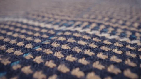 Macro patterned woolen fabric. Dolly clothing material blue beige color fibers Stock Footage 233526165