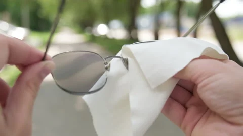 Macro of a person with a white microfiber cleaning cloth to wipe and clean .. Stock-Footage 339528842
