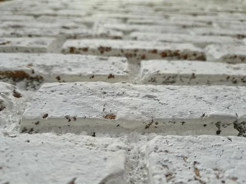 Macro perspective of a white painted rustic brick wall texture. Stock Photos