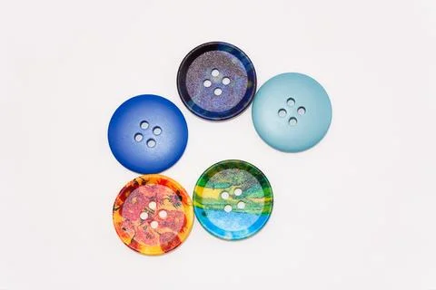 Macro photo of clothing buttons, a stack of multi-colored buttons on a white Stock Photos