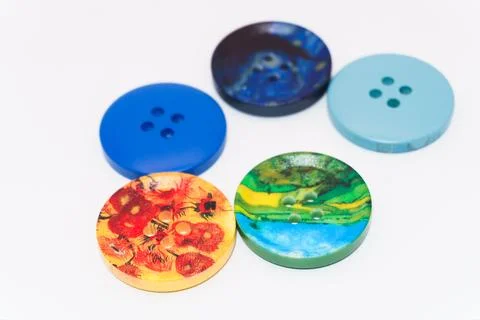 Macro photo of clothing buttons, a stack of multi-colored buttons on a white Stock Photos
