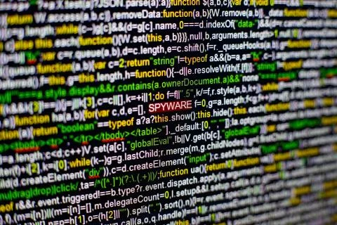 Macro photo of computer screen with program source code and highlighted SPYWARE 스톡 사진