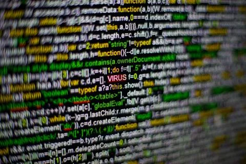 Macro photo of computer screen with program source code and highlighted VIRUS Stock Photos