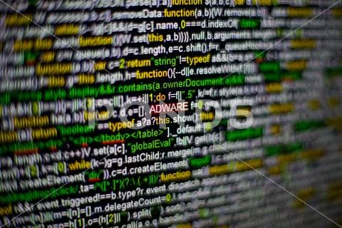 Macro photo of computer screen with program source code and highlighted ADWARE Stock Photos
