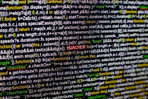 Macro photo of computer screen with program source code and highlighted HIJACKER Stock Photos