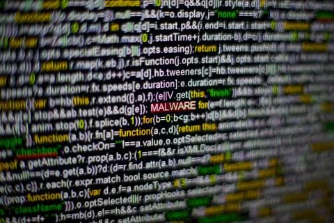 Macro photo of computer screen with program source code and highlighted MALWARE Stock Photos