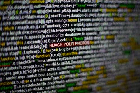 Macro photo of computer screen with program source code and highlighted HIJACK Foto stock