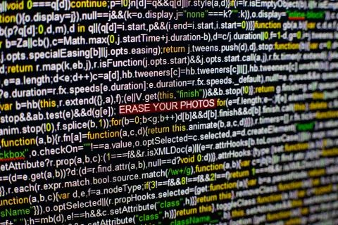 Macro photo of computer screen with program source code and highlighted ERASE Stock Photos