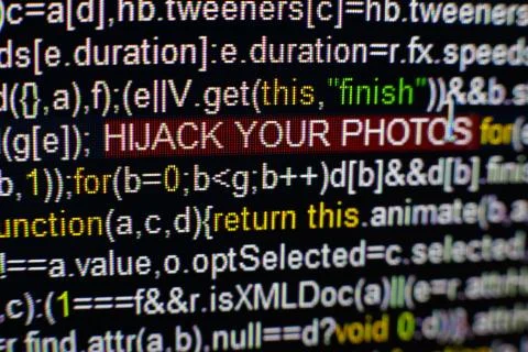 Macro photo of computer screen with program source code and highlighted HIJACK Foto stock