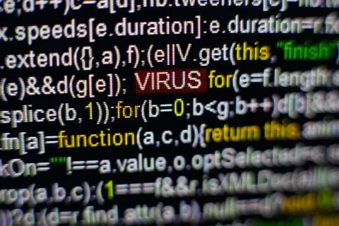 Macro photo of computer screen with program source code and highlighted VIRUS Foto stock
