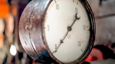 Macro photo of dial and pointer on retro manometer at steam power engine Stock Photos
