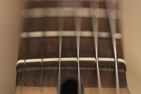 Macro photo of a guitar strings in perspective. Parts of the guitar. Stock Photos