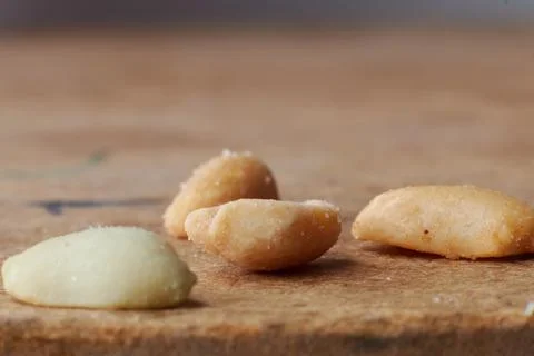 Macro photo of nuts on a wooden table, peanuts, beer snacks, blurred background Stock Photos
