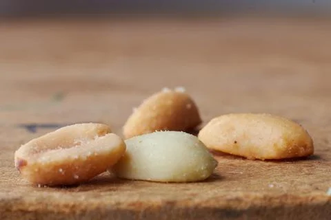 Macro photo of nuts on a wooden table, peanuts, beer snacks, blurred background Stock Photos