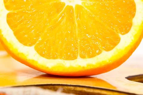 Macro photo of a section of an orange on the table. Stock Photos