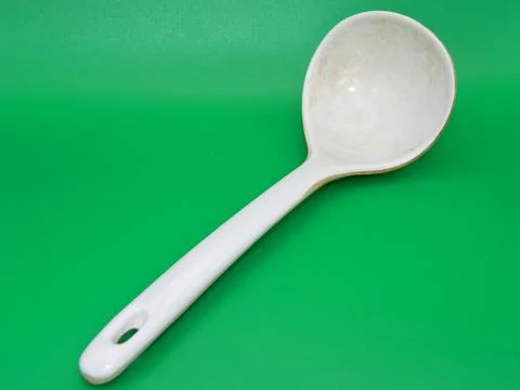 Macro photo of a spoon for all types of food on the green background. Use u.. Foto stock