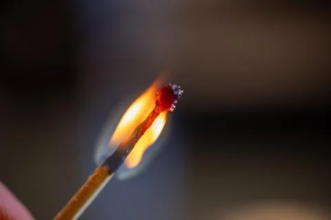 Macro photograph of a matchstick igniting, capturing the vibrant flame Foto stock