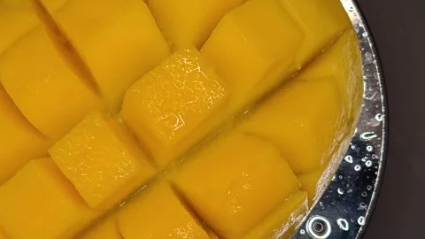 Macro photography of mango cubes in motion Stock Footage 329648013