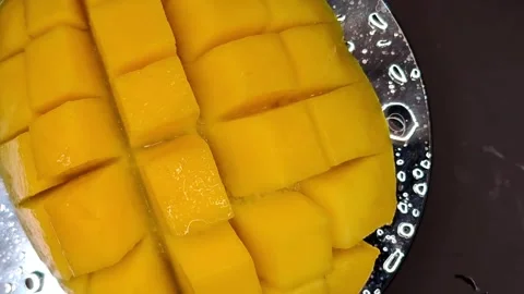 Macro photography of mango cubes moving in a circle Stock Footage 329666072