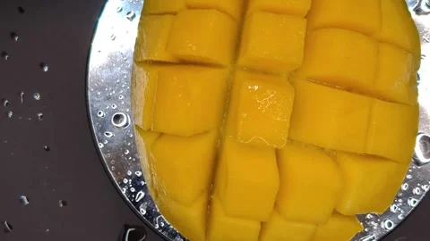 Macro photography of mango cubes swirling appetizingly Stock Footage 329645664