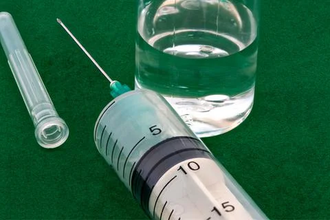 Macro photography of medical syringe and vaccine liquid in plastic bottle. Stock Photos