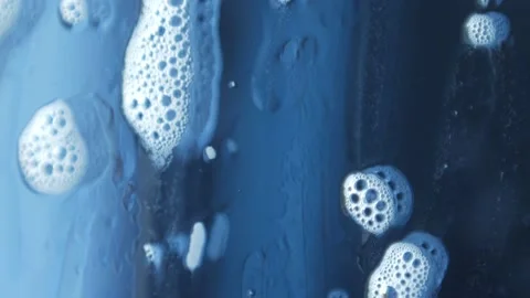 Macro photography of soap bubbles the window cleaning chemistry flows down the Stock Footage 153700016