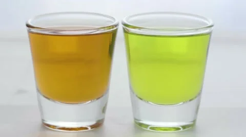 Macro picking up two shot glasses Stock Footage 68002886