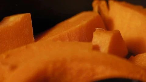 Macro, Pieces of Fresh Pumpkin Stewed on the Kitchen Stove Stock Footage 99556745