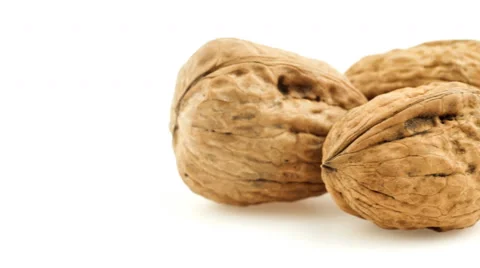 Macro pile of walnuts isolated on white sliding from side to side Stock Footage 47434732