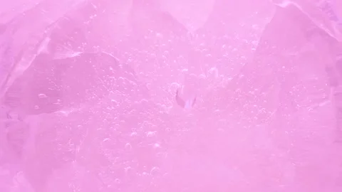 Macro pink broken ice texture with splashing water surface, drops and ripples Vídeo Stock 231954497