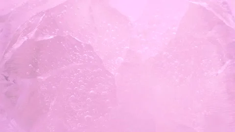 Macro pink broken ice texture with splashing water surface, drops and ripples Stock Footage 235282953