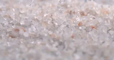 Macro of pink himalayan rock salt falls on wooden table for quality control Stock Footage 269320656