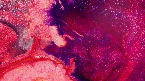 Macro of pink-orange and purple glitter ink blasted by air Stock Footage 314299879
