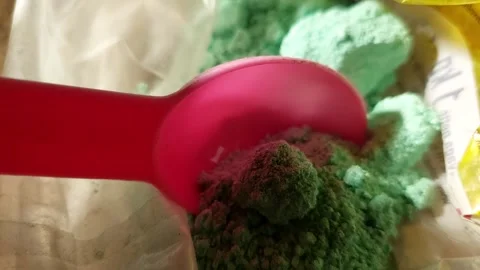 Macro of Pink Spoon Scooping Green Chemical Powder for Boiler Cleaning Stock Footage 333644257