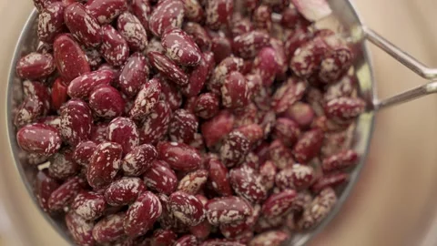 Macro pinto beans dropping from skimmer into water 4k 10bit Stock Footage 333285023