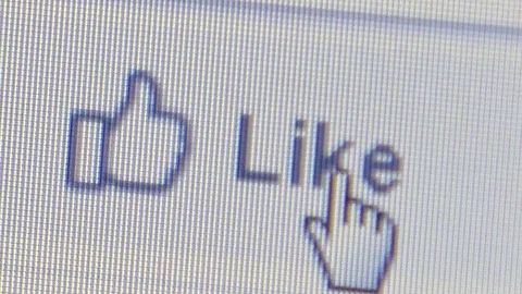 Macro pixel level view of hand cursor clicking on 'Like' icon Stock Footage 94669241