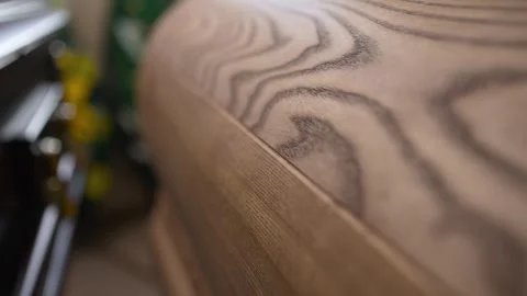 A macro plan of a coffin made of light wood . Video stock 308302181