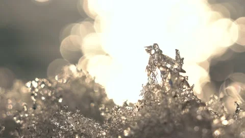 Macro plan of melting ice on the background of the sunset and the river. Stock Footage 151603112