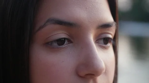 Macro portrait of the face of beautiful young brunette girl standing near the Stock Footage 114668053