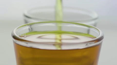 Macro pour of two shot glasses Stock Footage 68002924