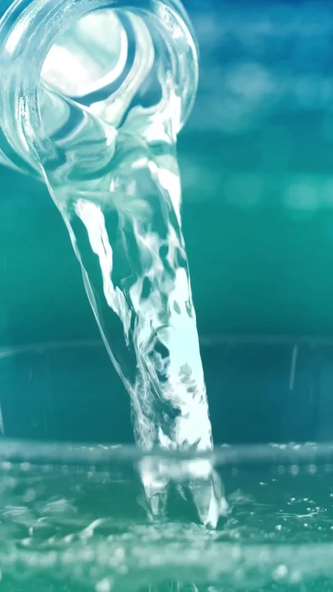 Macro of pouring drinking water from a bottle into a water glass Stock Footage 283534485